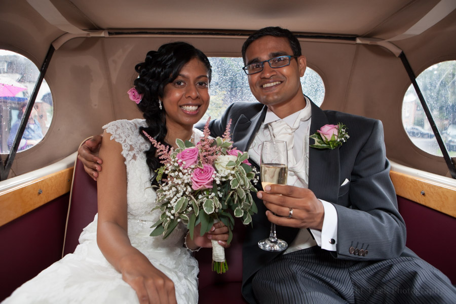 groom and bride inside wedding car